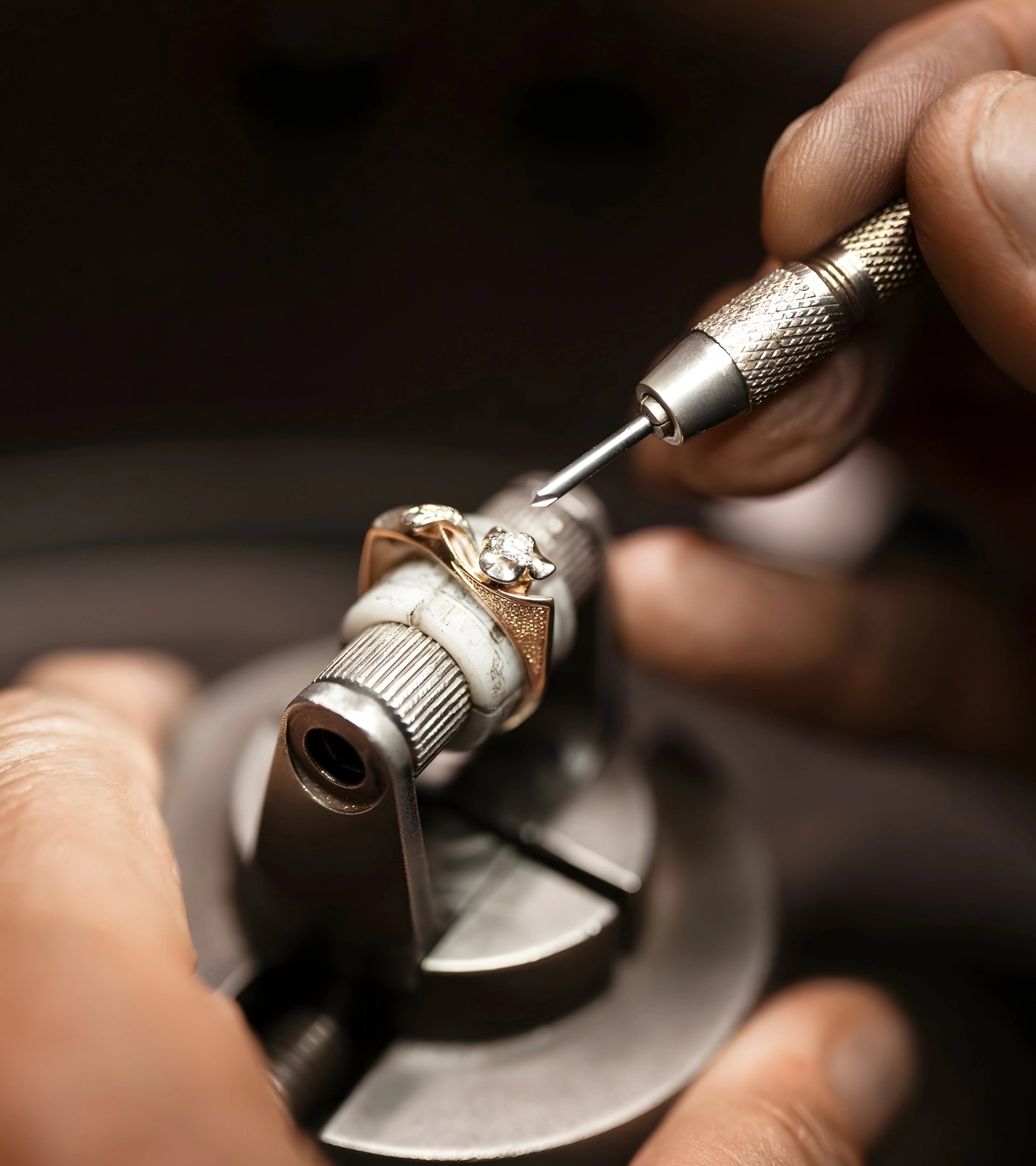 Close-up of a jeweler using precision tools to hand-set an ALTR lab-grown diamond into a gold ring.
