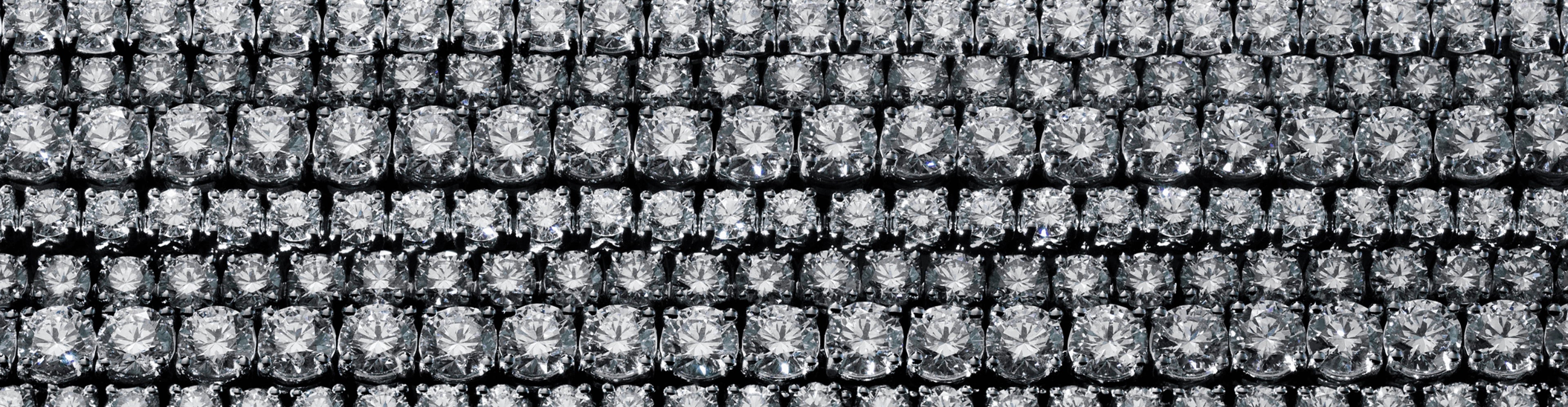 Macro background texture featuring high-clarity round brilliant lab-grown diamonds in a grid setting.