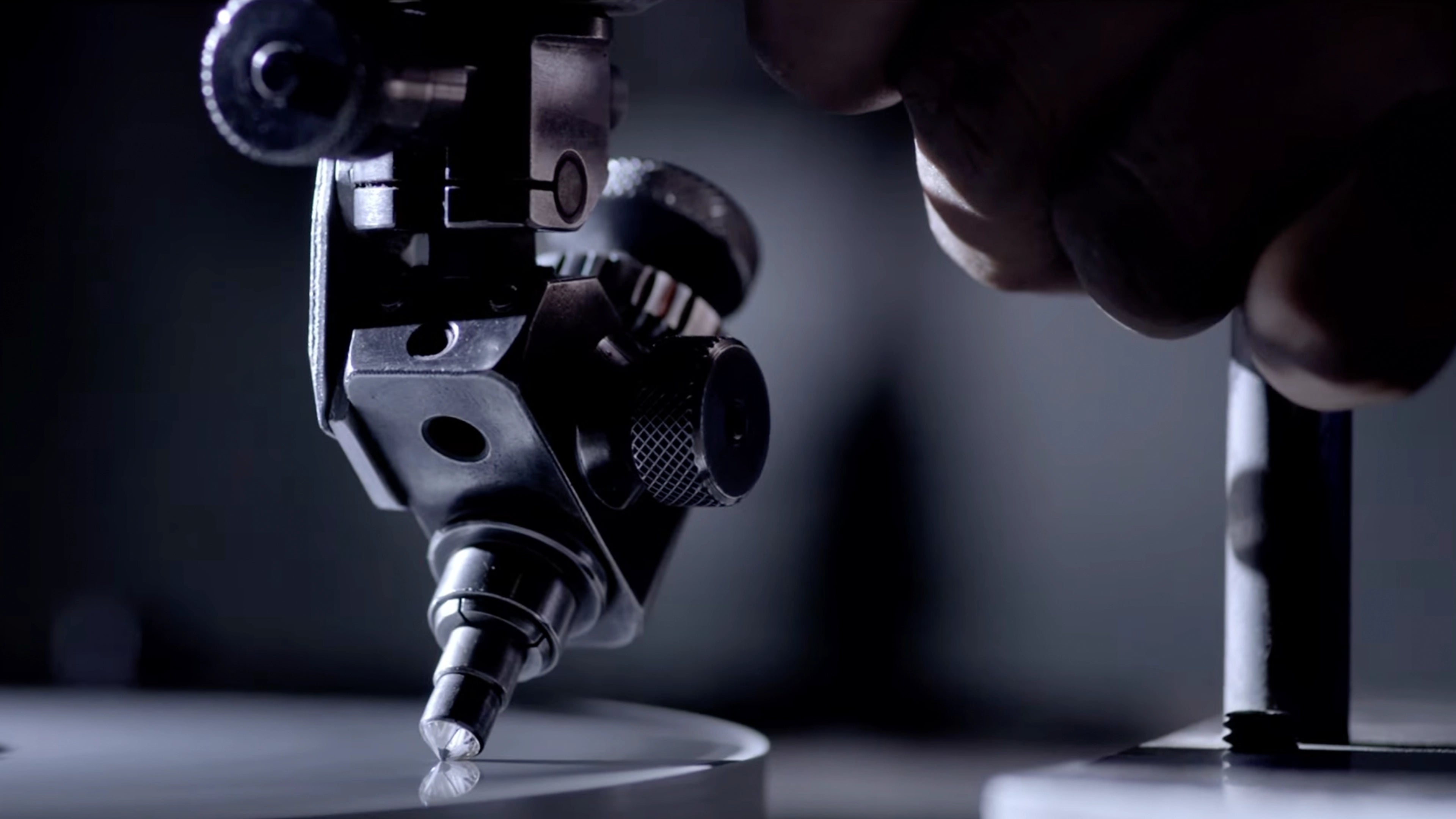 High-precision mechanical arm polishing a brilliant-cut ALTR lab-grown diamond in the manufacturing facility.
