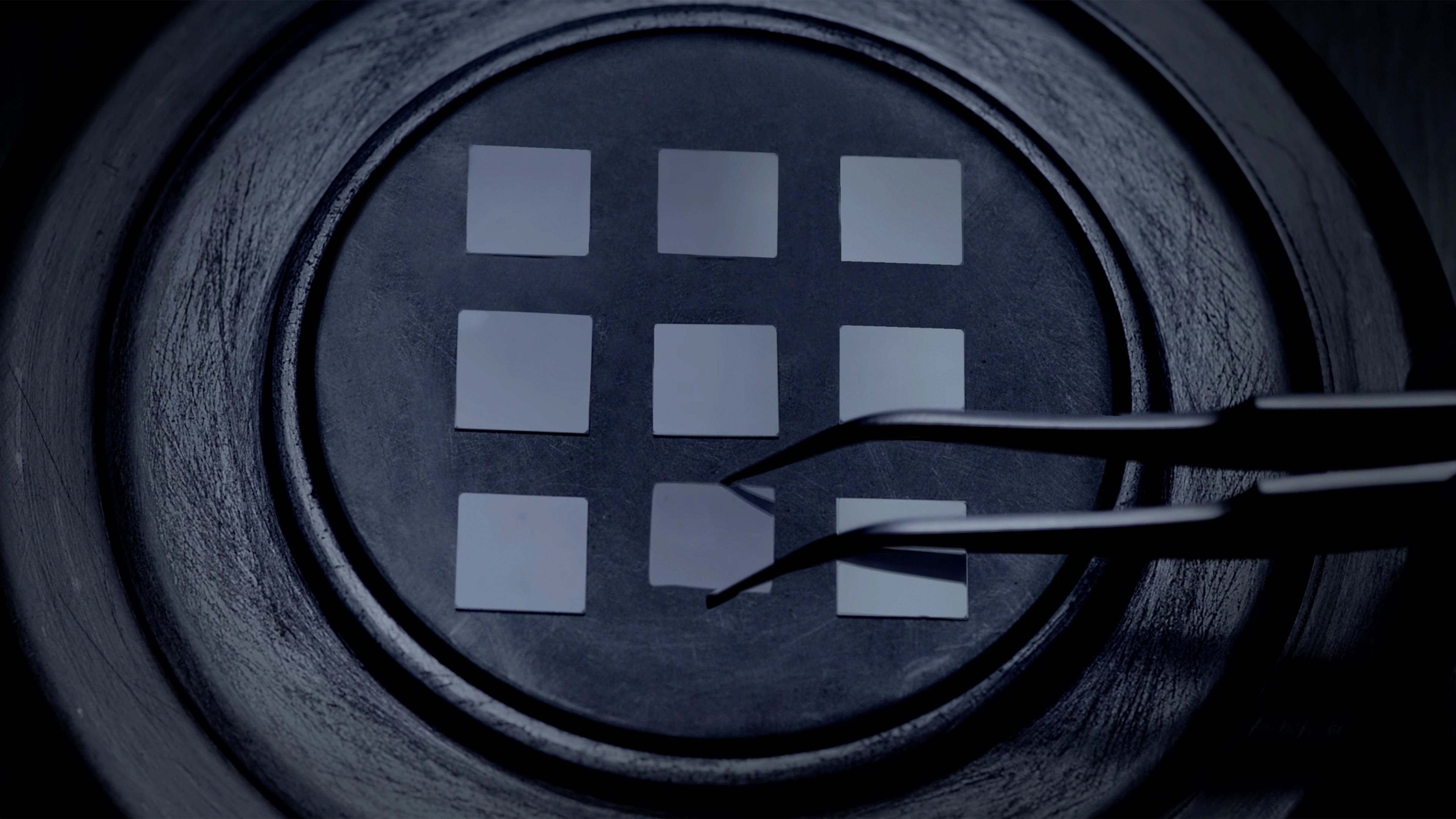 Tweezers placing square lab-grown diamond seeds onto a tray of the diamond growing chamber for the ALTR diamond creation process.