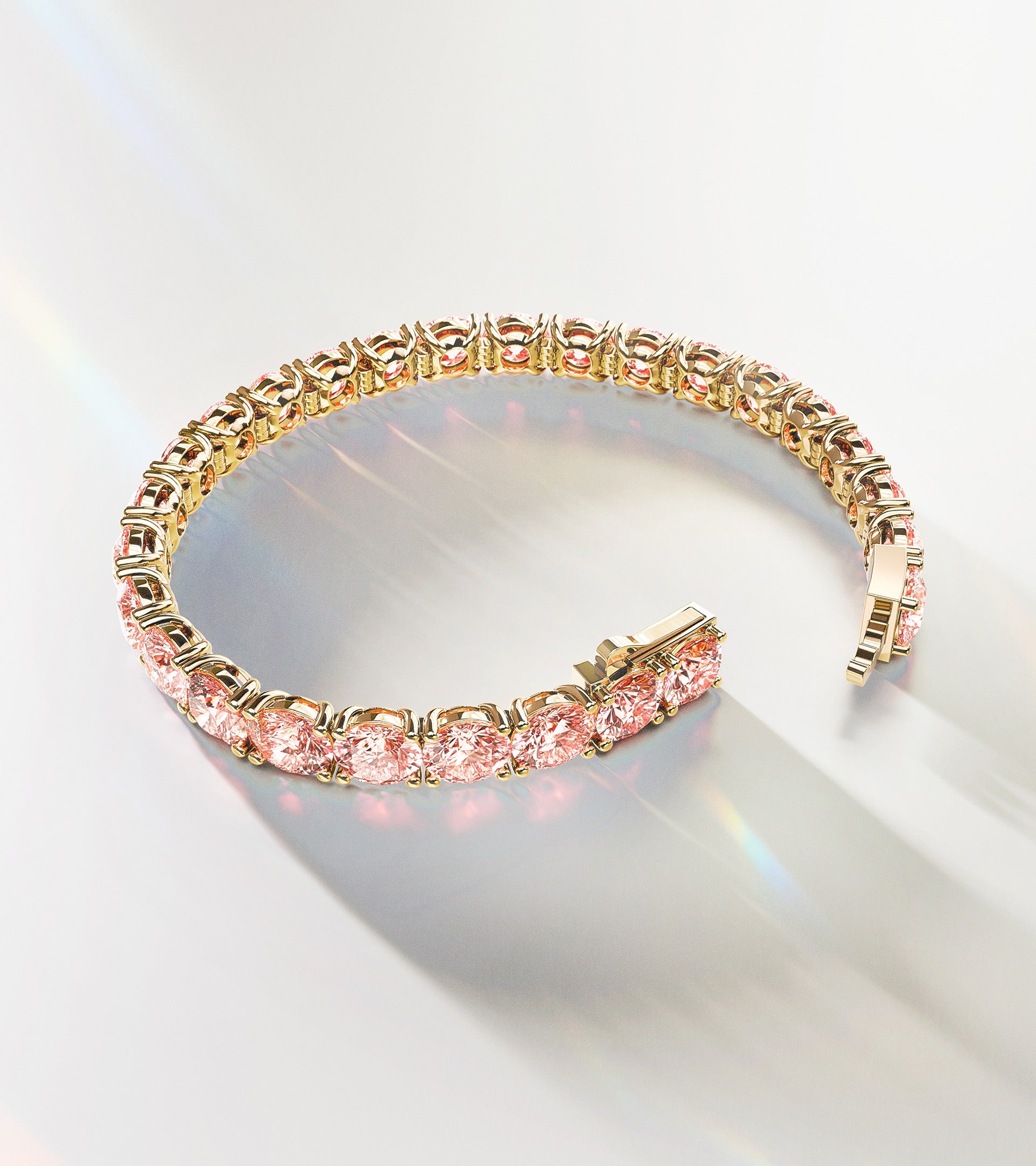 Luxury ALTR Created Diamonds tennis bracelet featuring round-cut pink lab-grown diamonds set in 14k yellow gold, displayed with elegant light reflections.