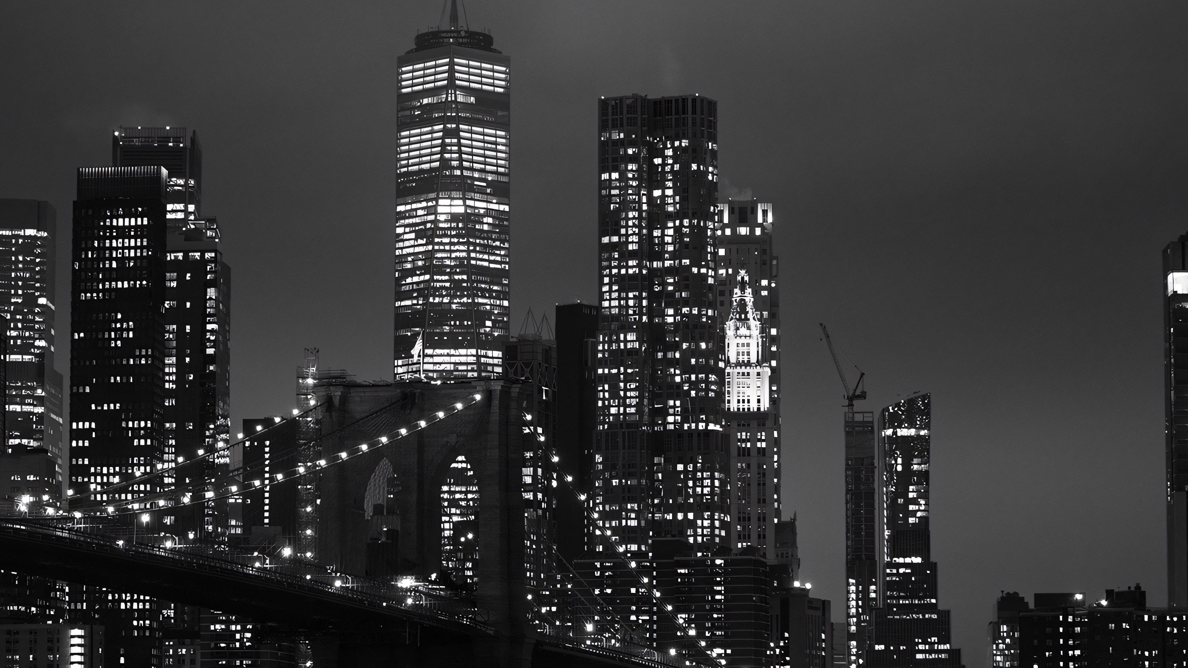 Black and white nighttime skyline of New York City featuring the Brooklyn Bridge and illuminated skyscrapers showcasing ALTR's birthplace