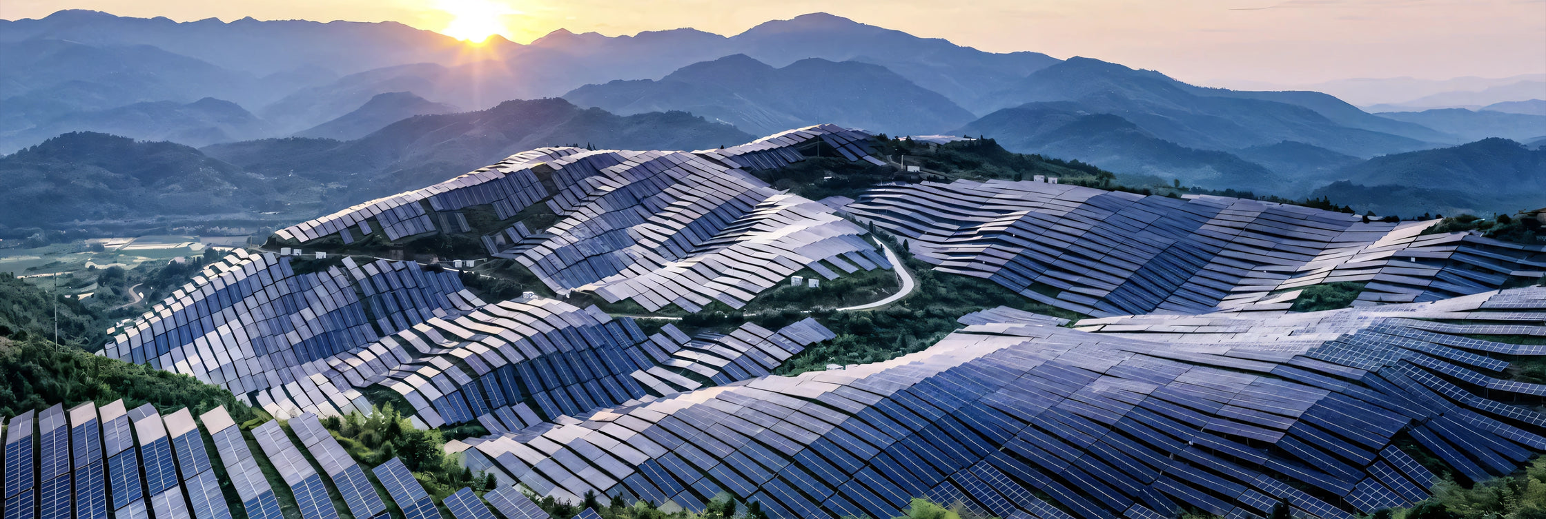 Aerial view of a massive solar energy farm in the mountains, highlighting ALTR's sustainable diamond growth.