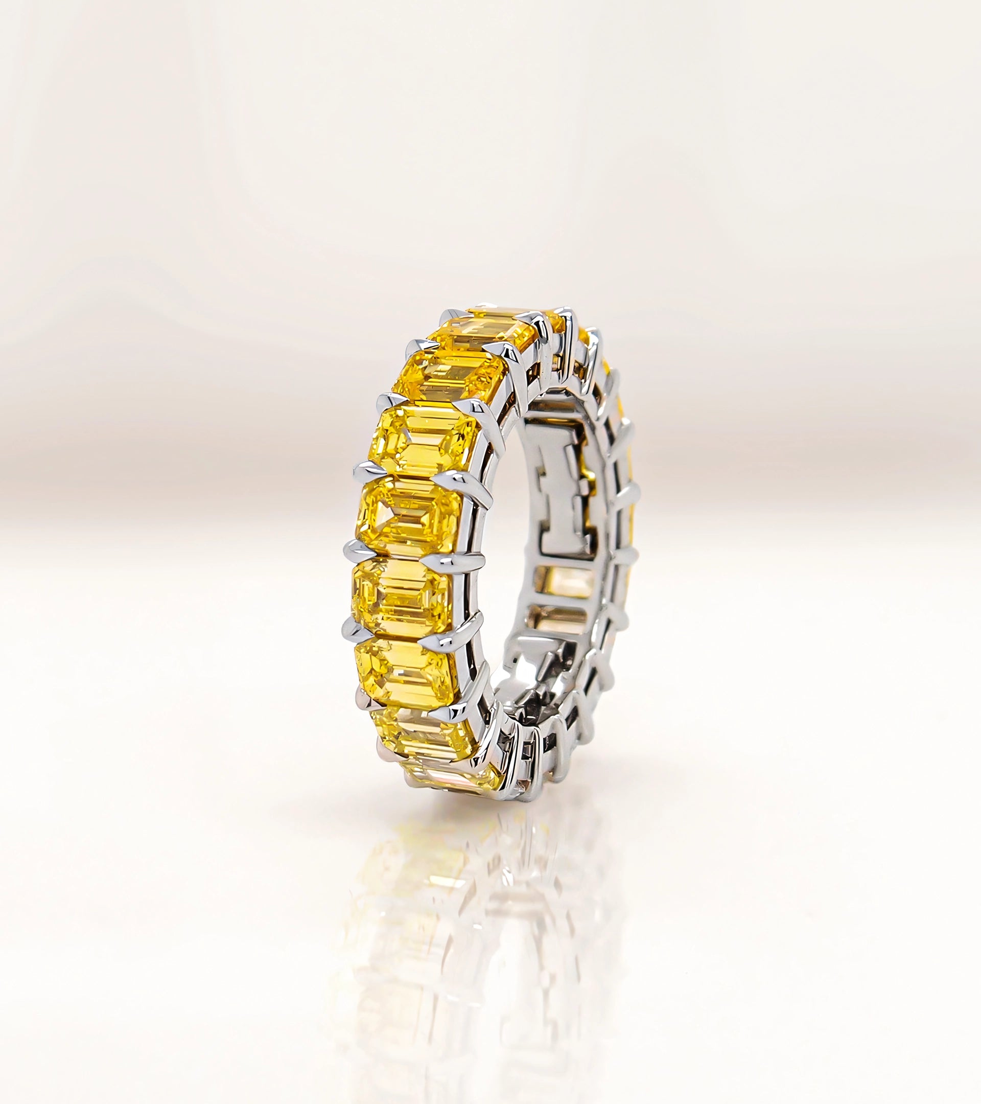 ALTR self-sizing eternity ring featuring emerald-cut yellow lab-grown diamonds in a patented self sizing platinum setting.