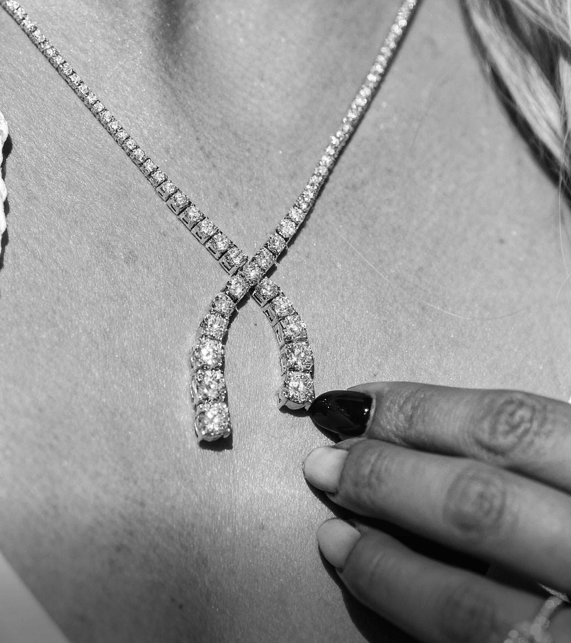 Close-up of a model wearing a unique bypass-style ALTR Created diamond tennis necklace.