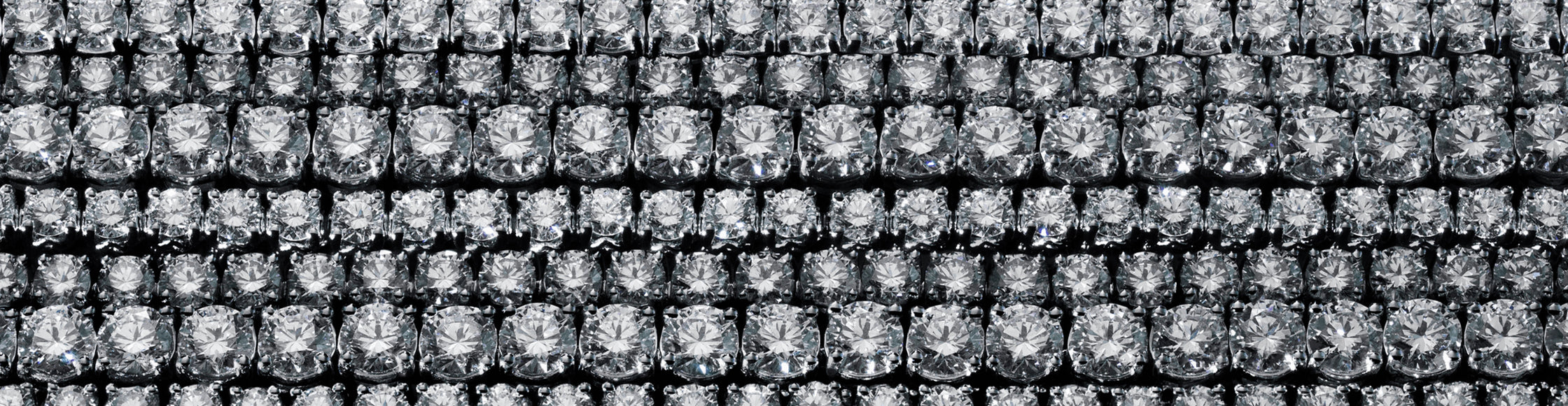 Macro background texture featuring high-clarity round brilliant lab-grown diamonds in a grid setting.